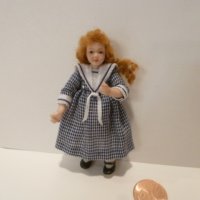 Little Girl wearing blue/white checkered dress